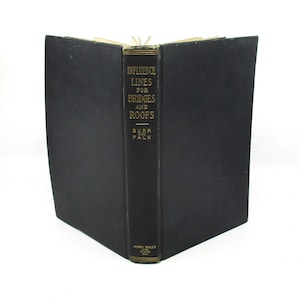 May include: An open book with a black cover and spine. The spine features the title "INFLUENCE LINES FOR BRIDGES AND ROOFS" in gold lettering. The author's name, BURR AND FALK, is also printed on the spine.