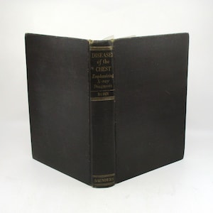 May include: A black hardcover book titled "Diseases of the Chest Emphasizing X-ray Diagnosis" by Rubin. The book is published by Saunders.