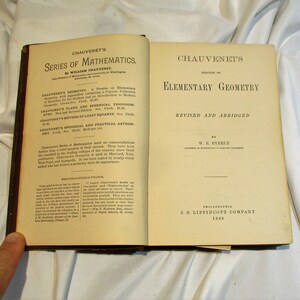 May include: A vintage book titled "Chauvenet's Elementary Geometry, Revised and Abridged" by W.E. Byerly, published by J.B. Lippincott Company in 1888.