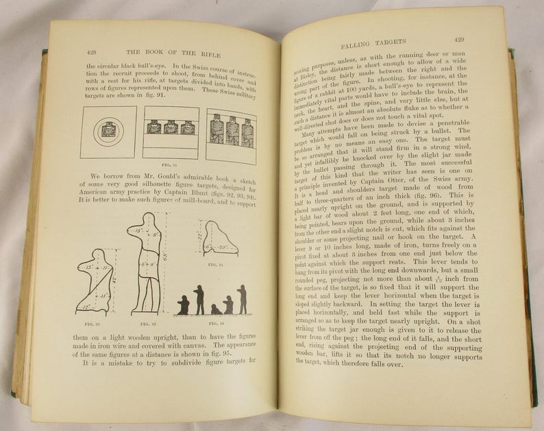 May include: An open book displaying text and illustrations on rifles and falling targets. Diagrams show target designs and construction. The pages are aged, with a visible binding.