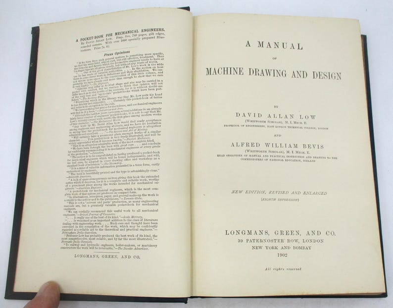 May include: A vintage book titled "A Manual of Machine Drawing and Design" by David Allan Low and Alfred William Bevis. The book cover is white with black text and is published by Longmans, Green, and Co. in 1902.