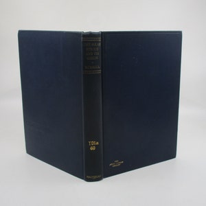 May include: A navy blue hardcover book with gold lettering on the spine. The title is "The Solar System and Its Origin" by H. Russell. The book is part of the "The  John  Wiley  Science  Series" and published by Macmillan.