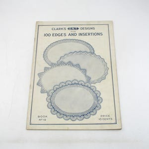 May include: A vintage booklet titled "CLARK'S ONT DESIGNS for 100 EDGES AND INSERTIONS." The cover features illustrations of lace doilies with intricate blue designs. The booklet is slightly aged, with the text "BOOK No 19" and "PRICE 10 CENTS" visible.