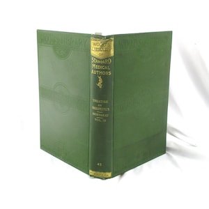 May include: A vintage hardcover book with a green cover and spine. The spine features gold lettering that reads "WOOD'S LIBRARY OF STANDARD MEDICAL AUTHORS". The book is titled "TREATISE ON THERAPEUTICS TROUSSEAU VOL. III".