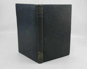 May include: A black hardcover book with gold lettering on the spine. The title is "The Wool-Gatherer" by  "S.R. Crockett".