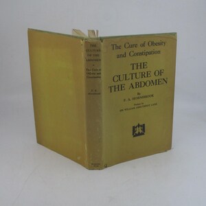 May include: A yellow book titled "The Culture of the Abdomen" by F.A. Hornibrook. Published by Sir William Arbuthnot Lane. The book cover also includes the text "The Cure of Obesity and Constipation".