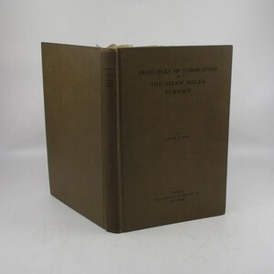 May include: A brown book titled "Principles of Combustion in the Steam Boiler Furnace" by Arthur D. Pratt. The book was published by The Babcock & Wilcox Co. in New York.