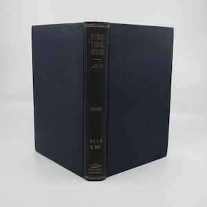 May include: A hardcover book titled "Structural Geology" by Leith. The book has a dark blue cover and a black spine with gold lettering. The word "Revised" is printed below the title. The book is a vintage edition.