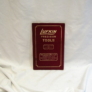 May include: A red booklet with gold lettering that reads "UFKIN PRECISION TOOLS STANDARD OF ACCURACY THE UFKIN RULE CO. SAGINAW, MICH, U.S.A. PRECISION TOOL DIVISION CATALOG No.7"