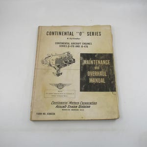 May include: A vintage book titled "Continental "O" Series" with a black and white illustration of an aircraft engine on the cover. The book is a maintenance and overhaul manual for Continental aircraft engines, series 0-470 and 10-470. The book is published by Continental Motors Corporation, Aircraft Engine Division, Muskegon, Michigan, USA.