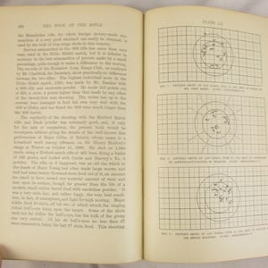 May include: An antique book, open to a double-page spread. The left page has text, including the title "THE BOOK OF THE RIFLE." The right page shows three diagrams with concentric circles and data points, possibly for ballistics.