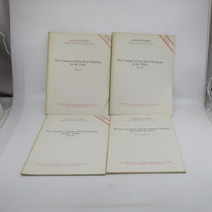 May include: Four white paperbacks with red titles and red borders. The titles are "The Conduct of East-West Relations in the 1980s" Part I, Part II, Part III, and "Western Security and Economic Strategy Towards the East".