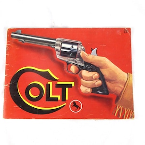 May include: A vintage advertisement featuring a Colt revolver held in a hand. The image is set against a red background with the Colt logo in yellow and black. The revolver is silver and black.