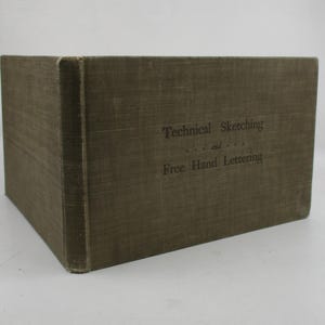 May include: A brown book with the title "Technical Sketching and Free Hand Lettering" on the cover.