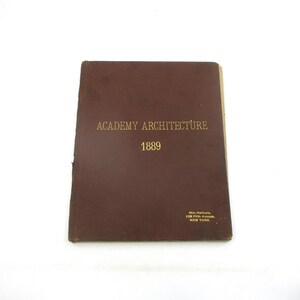 May include: A brown leather-bound book with gold lettering on the cover. The title is "Academy Architecture" and the year is "1889". The book was published by Wm. Helburn, 128 Fifth Avenue, New York.