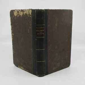 May include: A vintage, brown, leather-bound book with a black spine and gold lettering that reads "NATURAL PHILOSOPHY - PHELPS".