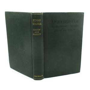 May include: A green hardcover book titled "Human Behavior: A Textbook of Psychology" by Colvin and Bagley. The book is published by MacMillan.