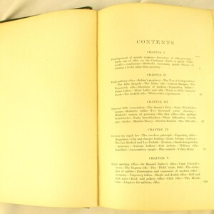 May include: An open book with aged, yellowed pages, revealing the contents page. The text details chapters and subheadings on rifles and related subjects. The book is open at a double-page spread.