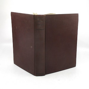 May include: A dark brown hardcover book with the title "The Works of Edgar Allan Poe" printed on the spine.