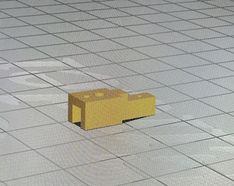 May include: A gold-colored plastic connector with four holes. The connector is designed to connect two pieces together.