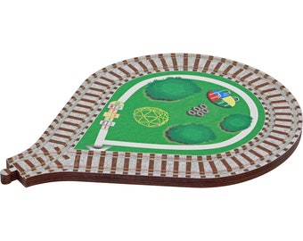 May include: A wooden train track set with a green park scene in the center. The park features a diamond-shaped playground, trees, and a swing set. The track is brown with white lines and the numbers 1-10 are printed on the side.