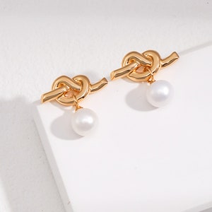 Sterling Silver Heart Knot Earrings Playful and lovely heart knot inlaid with natural pearls Earrings