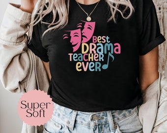 May include: Black t-shirt with a colorful graphic that says "Best Drama Teacher Ever" with two pink theater masks and a musical note.