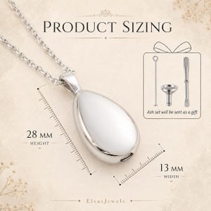 Op de afbeelding: Een zilverkleurige druppelvormige hangerketting met een witte, glanzende kern. De hanger is 28 mm hoog en 13 mm breed. De afbeelding bevat een kleine assenset als cadeau.