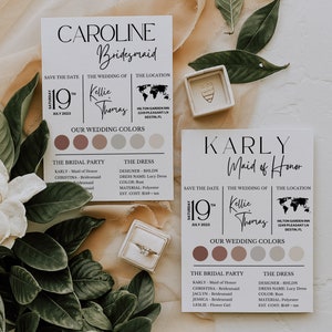 Peut inclure: Deux cartes d'invitation de mariage sur le th&egrave;me rustique. Les cartes sont d&eacute;cor&eacute;es de verdure et d'un &eacute;crin &agrave; bague. Le texte sur les cartes indique "Caroline Bridesmaid" et "Karly Maid of Honor". Les cartes indiquent &eacute;galement la date du mariage, les noms du couple et le lieu du mariage.