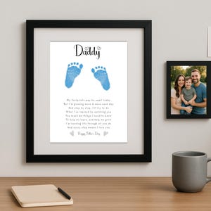 May include: A framed print with a blue baby footprint design and a poem that reads "Daddy, My footprints may be small today, But I'm growing more & more each day, And step by step, I'll try to do, What I've learned by watching you, You teach me things I need to know, To help me love, and help me grow, I'm learning life through all you do, And every step means I love you, Happy Father's Day".