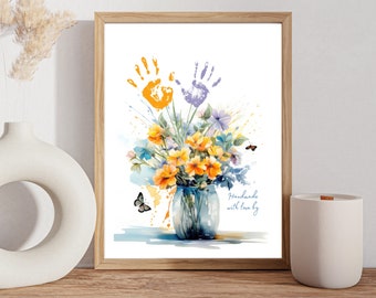 May include: A watercolor painting of a bouquet of yellow flowers in a blue vase with two handprints above the flowers. The handprints are orange and purple. The text "Handmade with love by" is at the bottom of the image.
