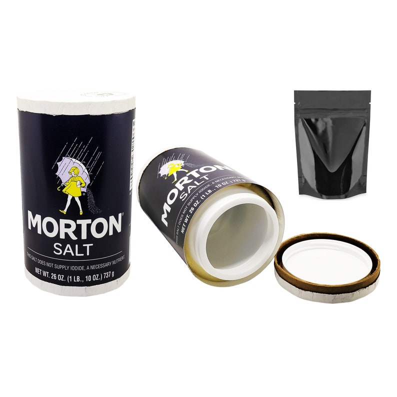 May include: A Morton Salt container with a blue and white label featuring a girl holding an umbrella. The container is open and the lid is off. The container is a secret stash container.