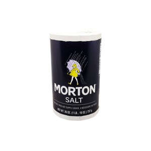 May include: A blue and white cylindrical container of Morton Salt. The container features a girl walking with an umbrella in the rain. The text on the container reads "Morton Salt" and "Net Wt. 26 oz. (1 lb., 10 oz.) 737 g".