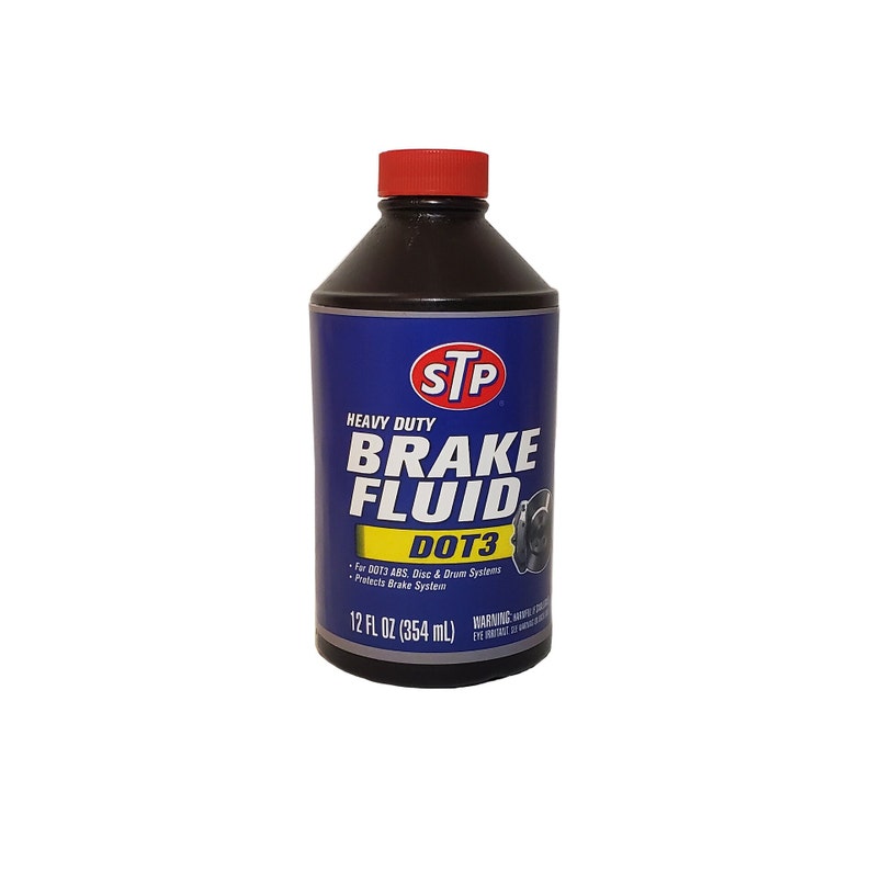 May include: A 12-fluid ounce bottle of STP Heavy Duty Brake Fluid DOT3. The bottle is blue and yellow with a red cap. The bottle is labeled with the STP logo and the text "Heavy Duty Brake Fluid DOT3".