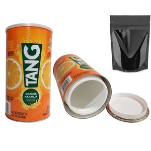 May include: Orange Tang drink mix in a cylindrical can with a white lid. The can is orange with the word "TANG" in green and white, and orange slice graphics. A black pouch is also in the image.