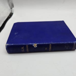 May include: A blue hardcover book titled "I.C.S. Handbook for Chemists." The book has a worn appearance with visible wear and tear on the cover and spine. The book is lying on a white surface.