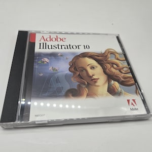 May include: Adobe Illustrator 10 software in a clear plastic case. The cover art features a woman with long, flowing hair and a soft, artistic background. The Adobe logo is visible.