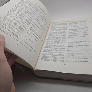 May include: A close-up of a book's index page with a list of authors and their works. The book is open and the pages are white with black text. The book is titled "List of Contributors".