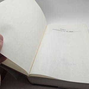 May include: Open book with the title "Peake's Commentary on the Bible" on the right page.