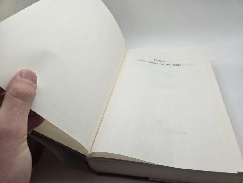May include: Open book with the title "Peake's Commentary on the Bible" on the right page.