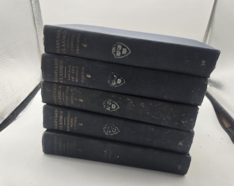 May include: A stack of five dark blue hardcover books from the Harvard Classics series. Each book has the series title and a volume title printed in white. The books are stacked at an angle, with the spines visible.