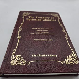 May include: A maroon hardcover book titled The Treasury of Christian Classics with gold foil lettering and decorative corner flourishes. The cover lists four books in one and the series name The Christian Library in a textured leather-like finish.