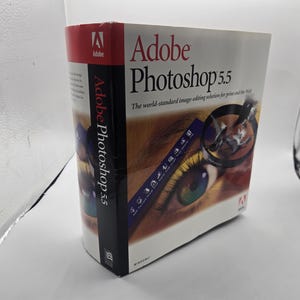 May include: A white ceramic mug with a black handle and the text "But First, Coffee" in a black, bold font. The mug is on a white surface. The mug is likely 11 ounces.