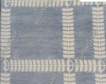 May include: A blue and white patterned rug with a geometric design. The rug has a subtle texture and a modern aesthetic.
