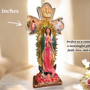 May include: A religious figurine of the Virgin Mary, approximately 12 inches tall, with a gold halo and crown. The figure is dressed in a pink and green robe, standing on a base with roses. The text says "Nlartesania Mexicana Exclusive Designs."