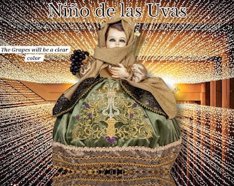 May include: A figurine of a child dressed in a green and gold gown with a brown shawl. The child is holding a bunch of grapes. The figurine is titled "Niño de las Uvas" and the text "The Grapes will be a clear color" is written below the figurine.