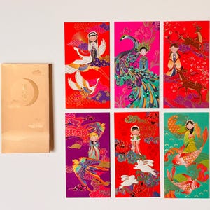 May include: A set of six rectangular envelopes featuring vibrant, detailed illustrations of figures with animals like cranes, peacocks, deer, birds, rabbits, and fish, alongside one plain gold envelope embossed with a crescent moon and clouds.