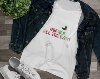 May include: White tank top with the text "Gingle All The Way!" in red, green, and gold lettering with a holly sprig graphic. The tank top is lying on a wooden surface with a denim jacket and white trainers.