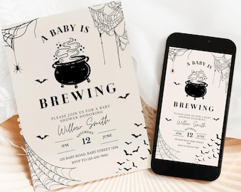 May include: A baby shower invitation with a Halloween theme. The invitation features the text "A Baby is Brewing" with a cauldron graphic, bats, and spiderwebs. A smartphone displays the same design.