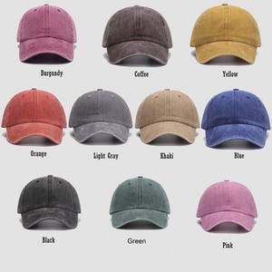 May include: Ten different colored baseball caps with a distressed look. The colors are burgundy, coffee, yellow, orange, light gray, khaki, blue, black, green, and pink.